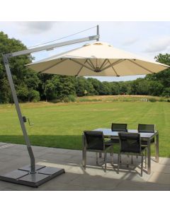 tilting cantilever with white canopy  open over a patio table in a garden